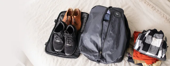 Clothes before and after vacuum compression in the Voyge backpack, about half the size